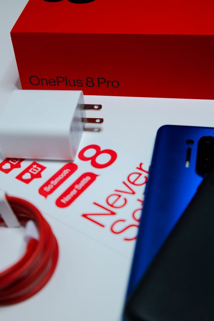 about-us-01 Close-up of OnePlus 8 Pro phone, charger, and packaging for an unboxing experience.