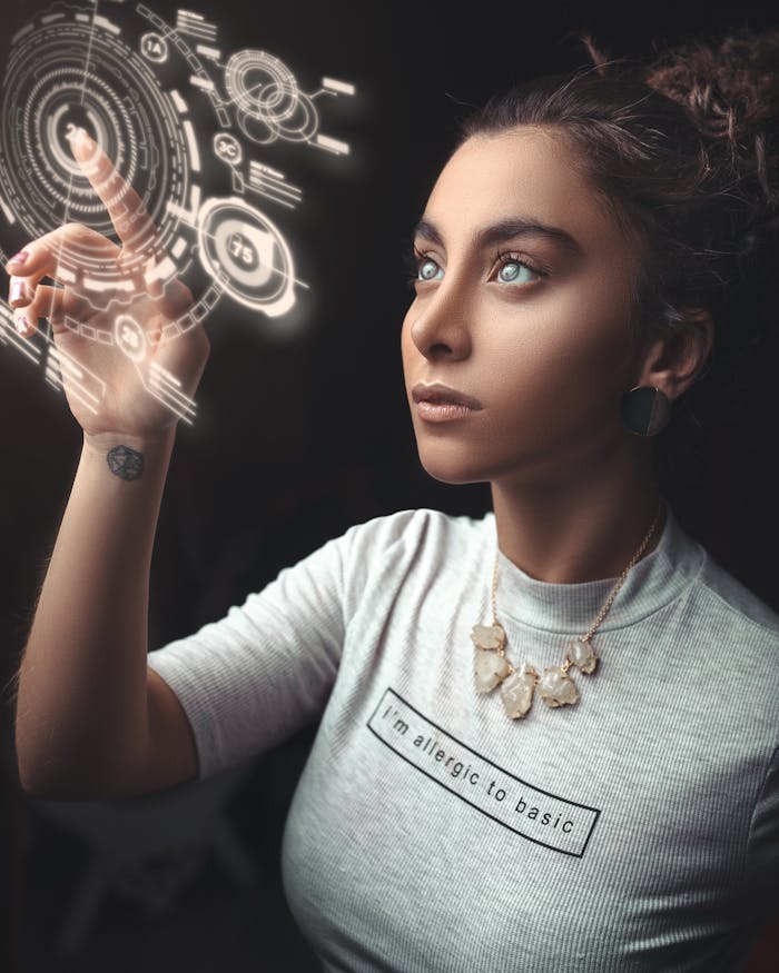 about-us-01 Woman in a modern setting interacting with a holographic user interface. Futuristic concept.